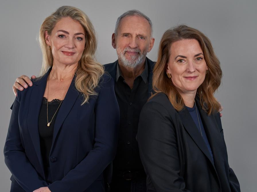 billede af en mand i midten bag to kvinder